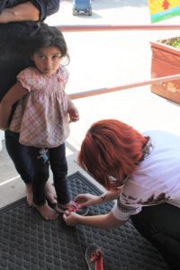 little girl getting shoelaces
